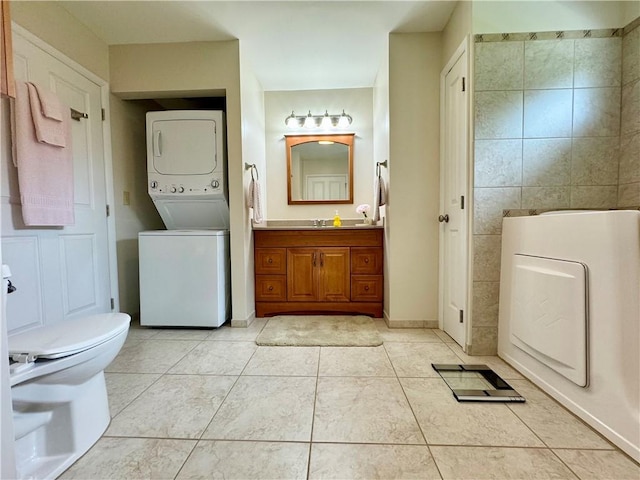 119 Park Ter, Big Flats, NY 14845 - bathroom featuring stacked washer / dryer, tile patterned floors, toilet, and vanity