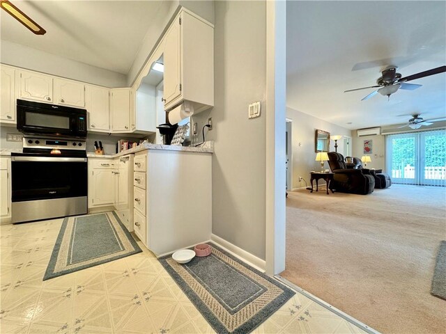 119 Park Ter, Big Flats, NY 14845 - kitchen featuring black microwave, electric stove, white cabinets, light countertops, and a ceiling fan