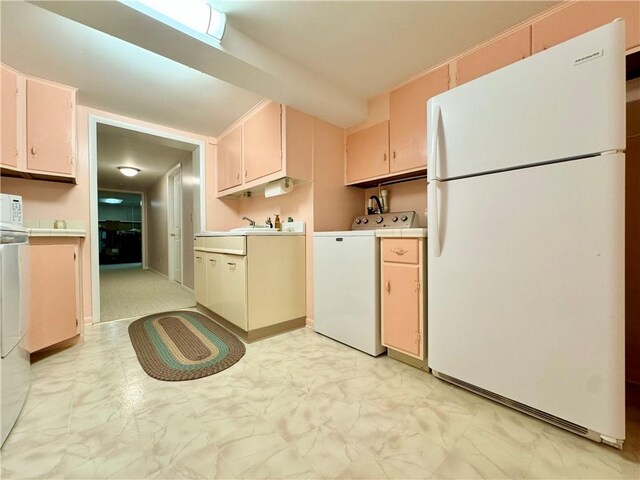 119 Park Ter, Big Flats, NY 14845 - kitchen with freestanding refrigerator, washer / clothes dryer, light countertops, and light marble finish floors