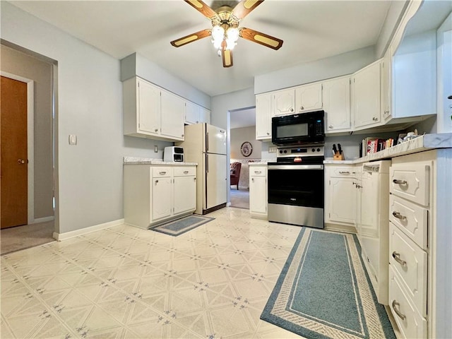 119 Park Ter, Big Flats, NY 14845 - kitchen with stainless steel range with electric cooktop, black microwave, freestanding refrigerator, light floors, and white cabinets