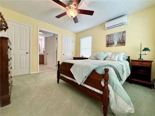 119 Park Ter, Big Flats, NY 14845 - bedroom featuring a wall unit AC, light colored carpet, ensuite bath, baseboards, and ceiling fan