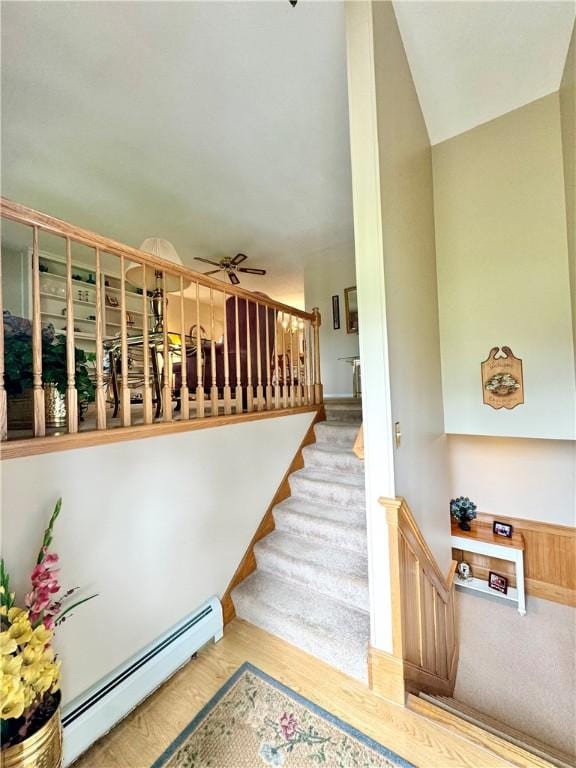 119 Park Ter, Big Flats, NY 14845 - stairs featuring a baseboard radiator, ceiling fan, and wood finished floors