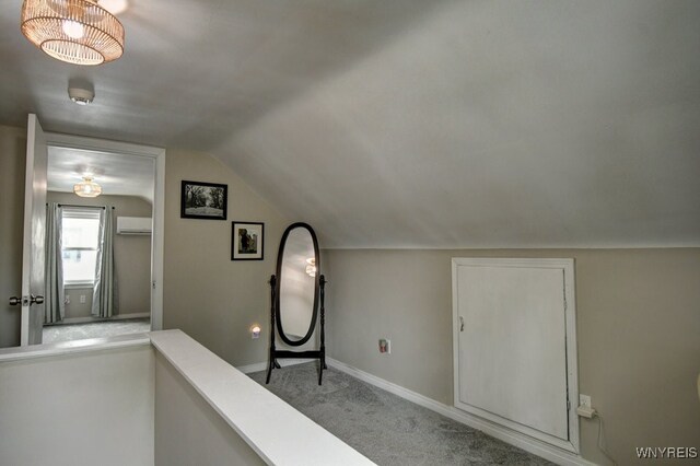 12 S Huxley Dr, Cheektowaga, NY 14225 - hall featuring a wall mounted AC, lofted ceiling, baseboards, and carpet flooring