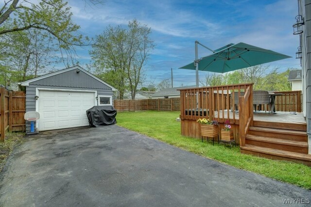 12 S Huxley Dr, Cheektowaga, NY 14225 - view of yard with a wooden deck, a garage, driveway, and an outbuilding