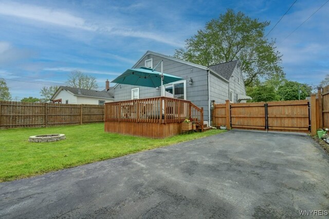 12 S Huxley Dr, Cheektowaga, NY 14225 - rear view of house featuring an outdoor fire pit, a wooden deck, a gate, and a shingled roof