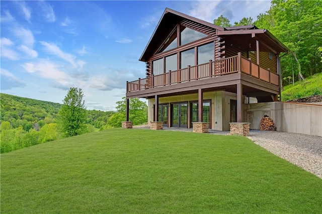 2050 County Highway 6, Middletown, NY 12455 - rear view of property with gravel driveway, a lawn, log siding, a deck, and a forest view