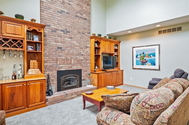 41 Pond Valley Cir, Penfield, NY 14526 - living area with light colored carpet, a towering ceiling, a fireplace, and baseboards