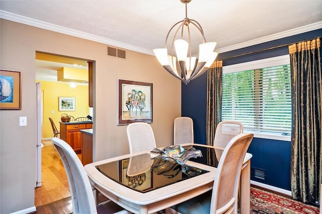 41 Pond Valley Cir, Penfield, NY 14526 - dining room featuring a chandelier, crown molding, wood finished floors, and baseboards