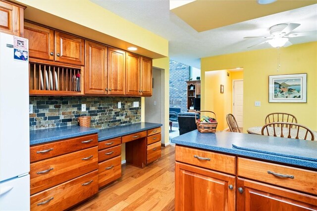 41 Pond Valley Cir, Penfield, NY 14526 - kitchen featuring freestanding refrigerator, light wood-style flooring, brown cabinets, decorative backsplash, and ceiling fan