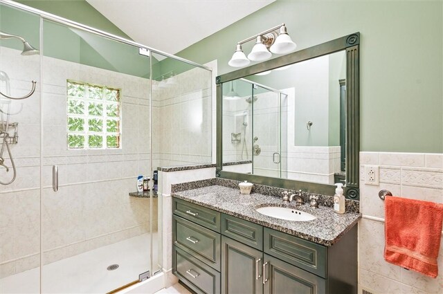 41 Pond Valley Cir, Penfield, NY 14526 - full bath featuring tile walls, vanity, a stall shower, and lofted ceiling