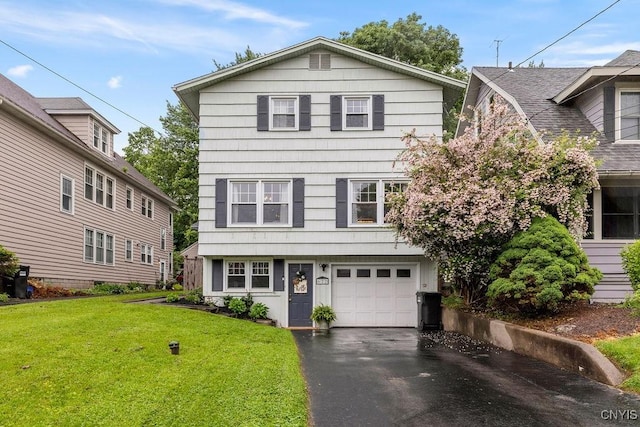 622 Stinard Ave, Syracuse, NY 13207 - view of front facade featuring an attached garage, a front lawn, and asphalt driveway