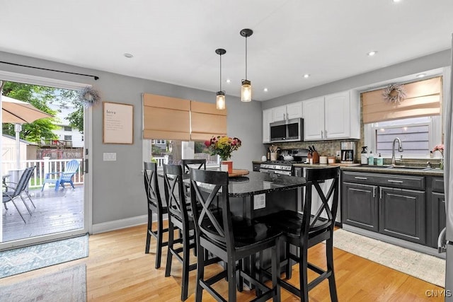 622 Stinard Ave, Syracuse, NY 13207 - kitchen with a sink, stainless steel appliances, white cabinetry, light wood-style flooring, and recessed lighting