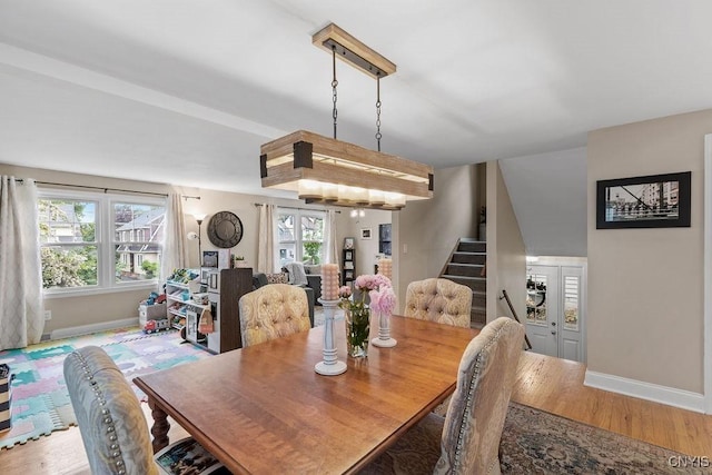 622 Stinard Ave, Syracuse, NY 13207 - dining room featuring baseboards, stairs, and wood finished floors