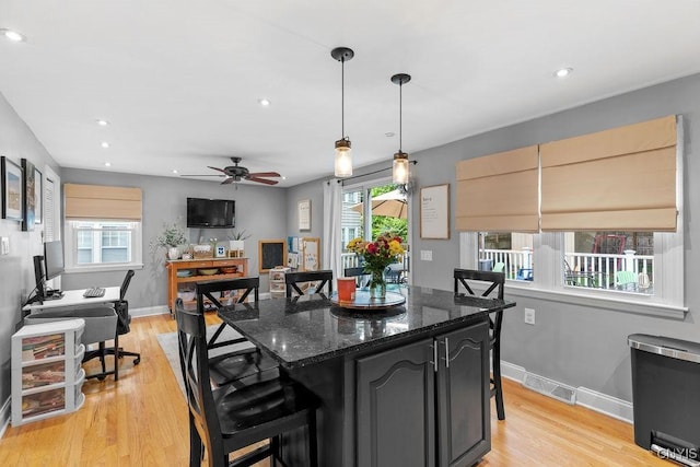 622 Stinard Ave, Syracuse, NY 13207 - kitchen featuring plenty of natural light, a center island, a breakfast bar, light wood-style floors, and recessed lighting