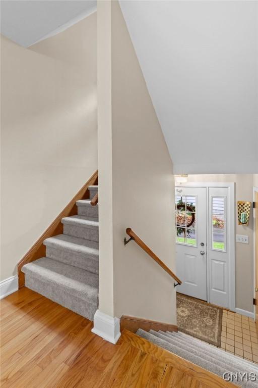 622 Stinard Ave, Syracuse, NY 13207 - staircase with baseboards, wood finished floors, and lofted ceiling