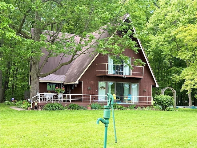 1476 Grange Hall Rd, Junius, NY 14532 - rear view of property featuring a balcony, a lawn, and metal roof