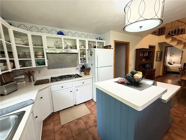 1476 Grange Hall Rd, Junius, NY 14532 - kitchen featuring stainless steel gas stovetop, freestanding refrigerator, a kitchen island, white cabinetry, and tasteful backsplash
