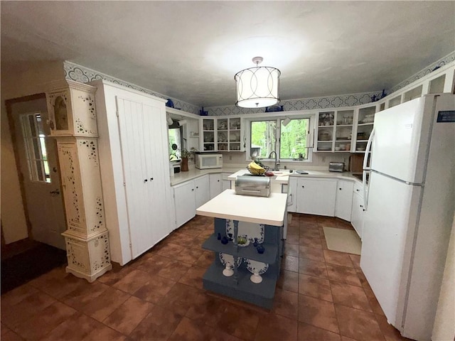 1476 Grange Hall Rd, Junius, NY 14532 - kitchen featuring white appliances, open shelves, light countertops, glass insert cabinets, and a kitchen island