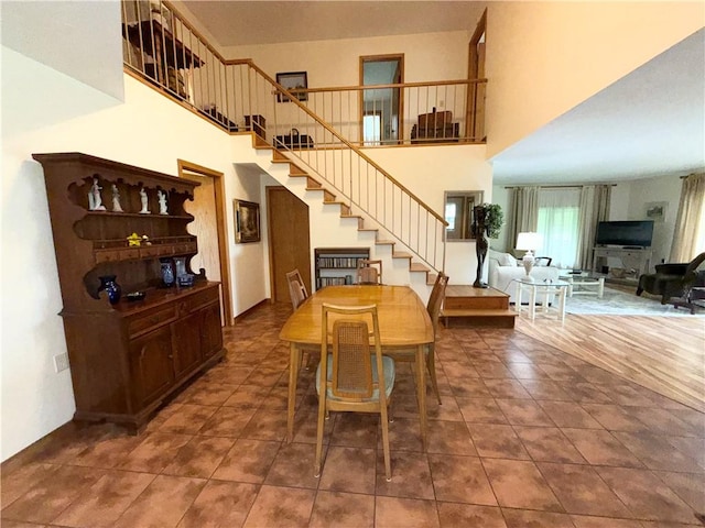 1476 Grange Hall Rd, Junius, NY 14532 - dining area with stairs, a towering ceiling, and tile patterned floors