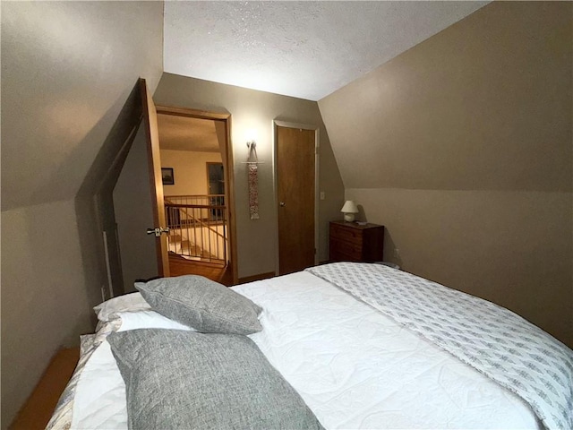 1476 Grange Hall Rd, Junius, NY 14532 - bedroom featuring lofted ceiling and a textured ceiling