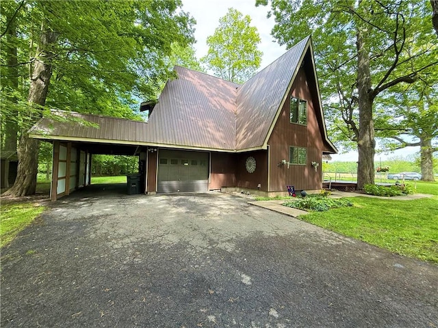 1476 Grange Hall Rd, Junius, NY 14532 - view of side of property featuring asphalt driveway, metal roof, a carport, a garage, and a lawn