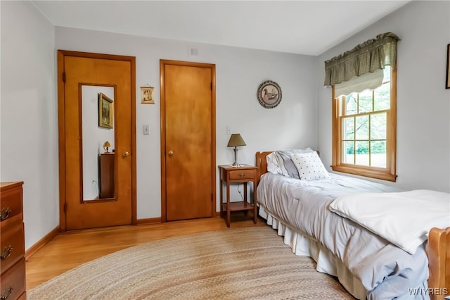 131 Idlewood Dr, Aurora, NY 14127 - bedroom with light wood-style flooring and baseboards