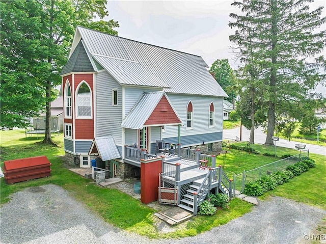28 Bridge St, Albion, NY 13302 - view of front of house with metal roof, a front yard, stairway, and a wooden deck