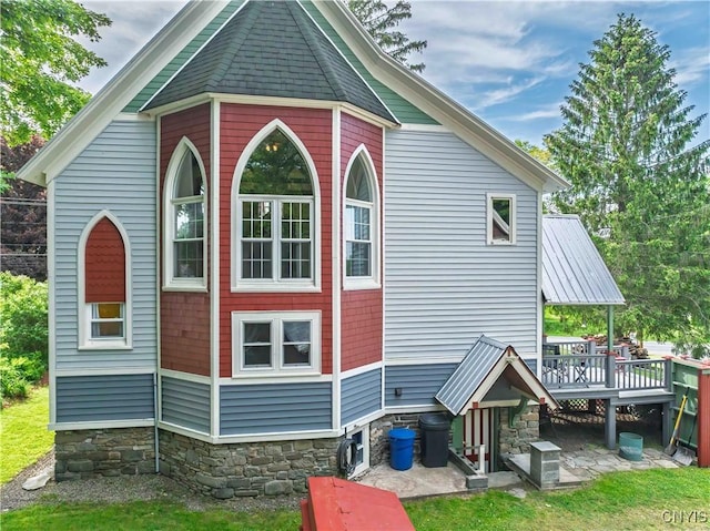 28 Bridge St, Albion, NY 13302 - view of property exterior with a wooden deck and stone siding