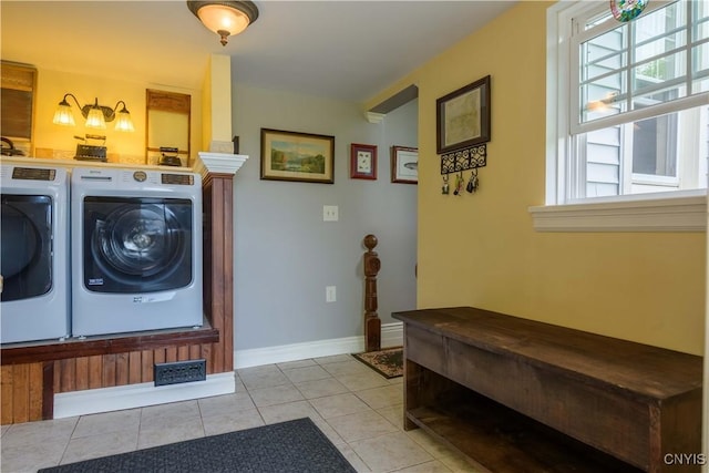 28 Bridge St, Albion, NY 13302 - laundry room featuring washer and clothes dryer, plenty of natural light, baseboards, and tile patterned flooring
