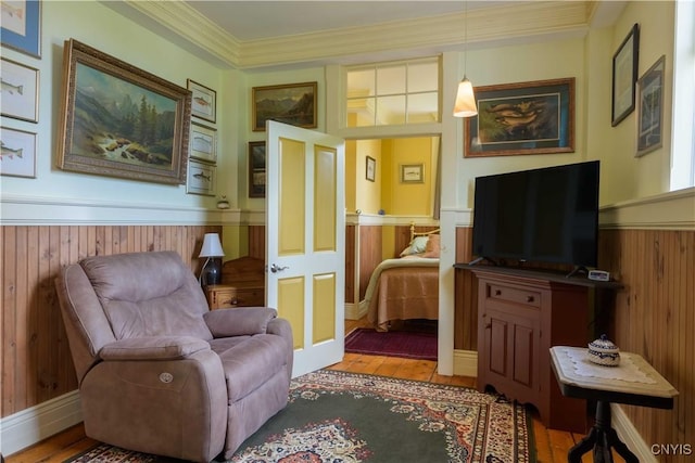 28 Bridge St, Albion, NY 13302 - sitting room featuring wainscoting, wood finished floors, wood walls, crown molding, and french doors
