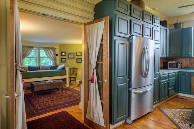 28 Bridge St, Albion, NY 13302 - kitchen with appliances with stainless steel finishes, light wood finished floors, ornamental molding, open floor plan, and light countertops