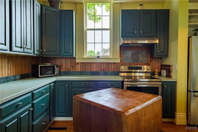 28 Bridge St, Albion, NY 13302 - kitchen with under cabinet range hood, stainless steel appliances, light countertops, and a center island