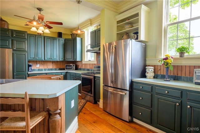 28 Bridge St, Albion, NY 13302 - kitchen with stainless steel appliances, a ceiling fan, light countertops, hanging light fixtures, and ornamental molding