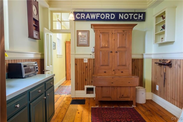 28 Bridge St, Albion, NY 13302 - mudroom featuring a wainscoted wall, light wood-type flooring, crown molding, and wood walls