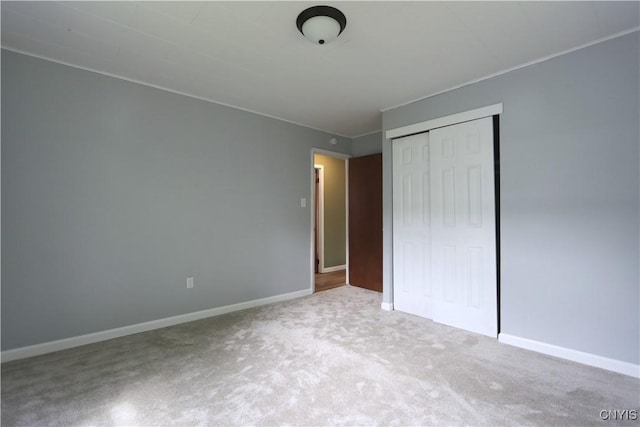 22245 Patricia Dr, Le Ray, NY 13601 - unfurnished bedroom featuring carpet floors, a closet, and baseboards