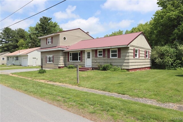 22245 Patricia Dr, Le Ray, NY 13601 - view of front of home featuring a front lawn, metal roof, and driveway