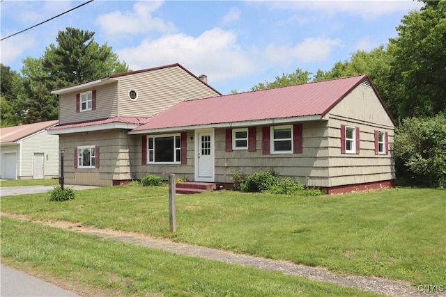 22245 Patricia Dr, Le Ray, NY 13601 - view of front of home with metal roof, a front yard, and a chimney