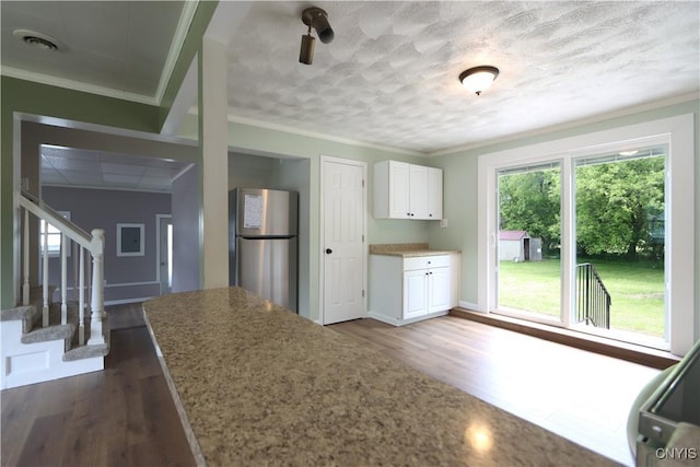 22245 Patricia Dr, Le Ray, NY 13601 - kitchen featuring freestanding refrigerator, dark wood-style flooring, white cabinetry, light stone counters, and a textured ceiling