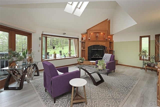 3485 Oran Delphi Rd, Pompey, NY 13104 - living room featuring vaulted ceiling, light wood-style floors, a skylight, a large fireplace, and baseboards