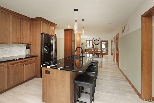 3485 Oran Delphi Rd, Pompey, NY 13104 - kitchen featuring a sink, dark countertops, stainless steel fridge, light wood-type flooring, and a breakfast bar area