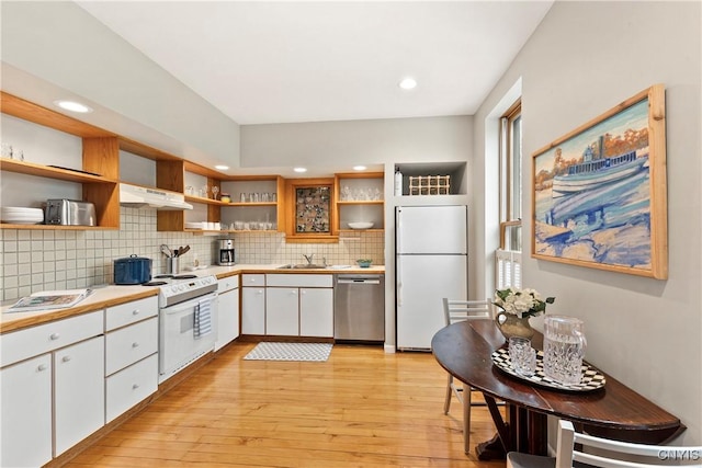 18 E Genesee St Unit 1, Skaneateles, NY 13152 - kitchen with white appliances, open shelves, light countertops, wall chimney range hood, and white cabinetry
