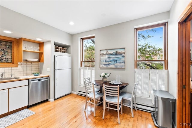 18 E Genesee St Unit 1, Skaneateles, NY 13152 - kitchen featuring stainless steel dishwasher, fridge, a sink, white cabinetry, and light countertops