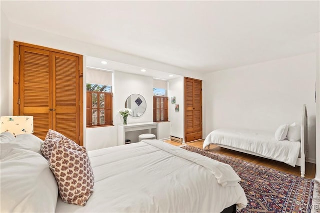 18 E Genesee St Unit 1, Skaneateles, NY 13152 - bedroom with wood finished floors, recessed lighting, a baseboard heating unit, and baseboards