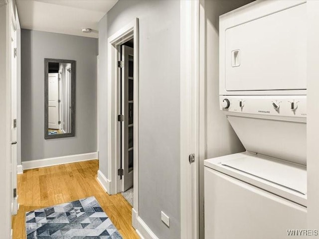 610 Main St Unit 501, Buffalo, NY 14202 - laundry area with stacked washer / dryer, light wood finished floors, and baseboards