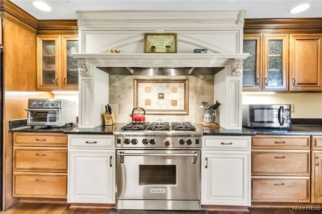 29 Brunck Rd, Lancaster, NY 14086 - kitchen featuring appliances with stainless steel finishes, glass insert cabinets, decorative backsplash, and custom range hood