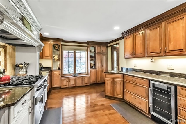 29 Brunck Rd, Lancaster, NY 14086 - kitchen featuring beverage cooler, high end range, light wood-style flooring, recessed lighting, and brown cabinets