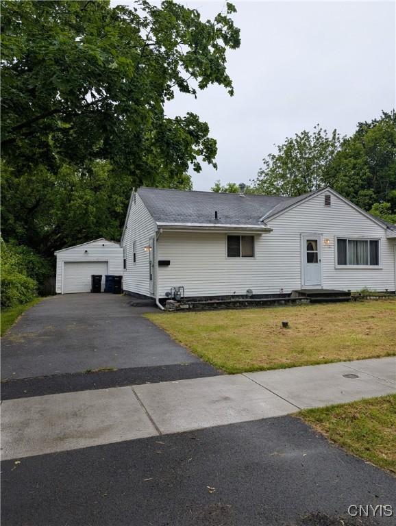 161 W Florence Ave, Syracuse, NY 13205 - view of front facade with an outdoor structure, a front lawn, a detached garage, and asphalt driveway