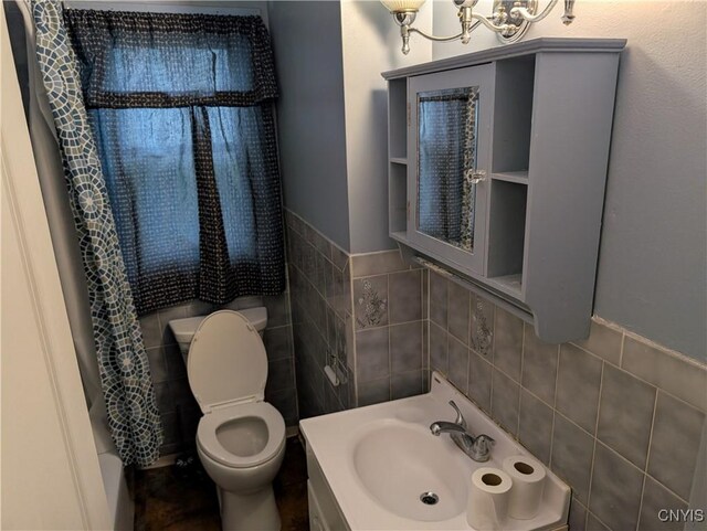 161 W Florence Ave, Syracuse, NY 13205 - bathroom featuring tile walls, toilet, vanity, and a chandelier