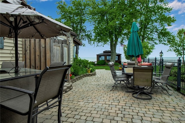 12383 Lake Forest Ln Unit 42, Yates, NY 14098 - view of patio with outdoor dining area and a water view