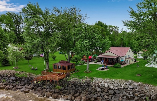 12383 Lake Forest Ln Unit 42, Yates, NY 14098 - view of home's community with a fire pit, an outbuilding, a lawn, and a wooden deck
